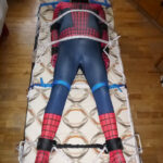 A slave as spiderman is restrained.