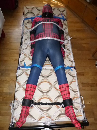 A slave as spiderman is restrained.