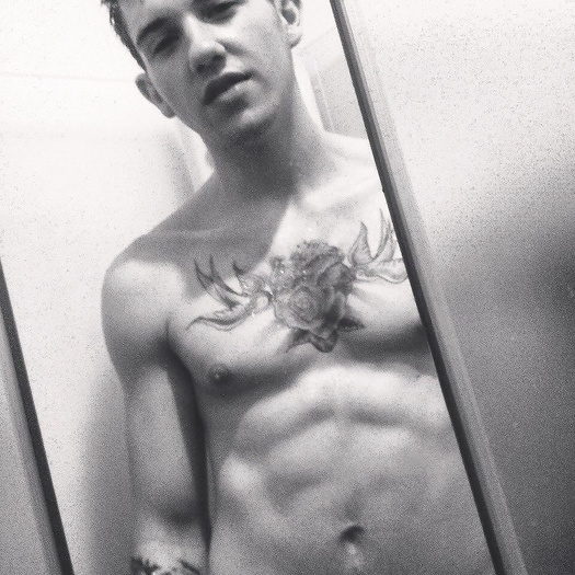 Almer shows off his tattoos and body